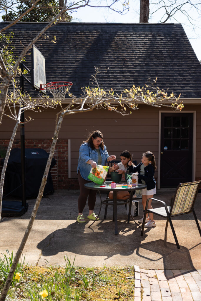 spring candid family photo idea - plant flowers on your patio or in your yard
